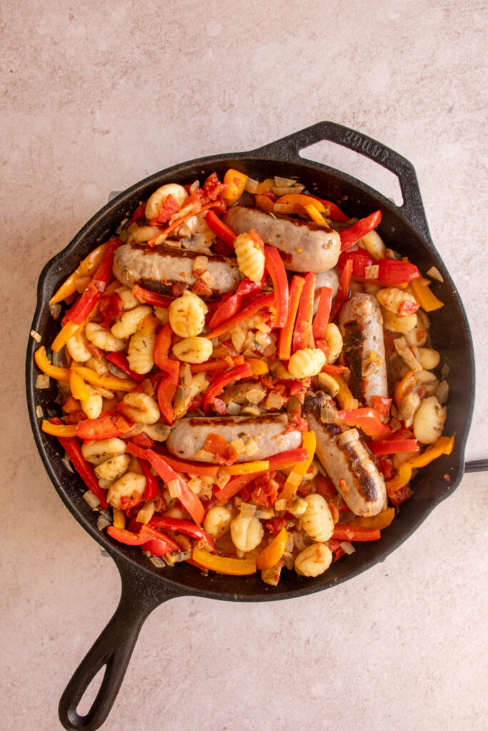 Gnocchi mixed in with the bell peppers and sausages for cooking.