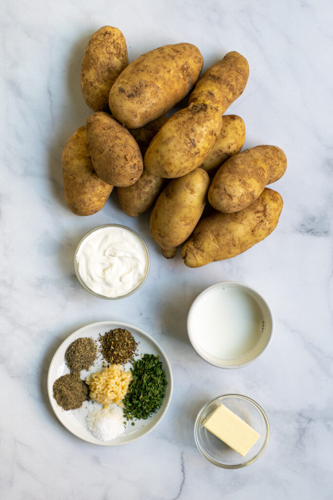 All of the ingredients to make instant pot mashed potatoes laid out on a table top. 