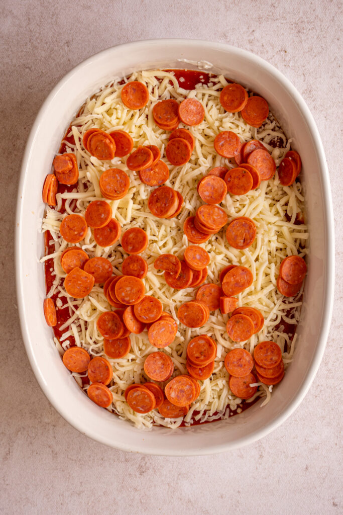 Mini pepperoni added to the top of uncooked cottage cheese pizza dip.