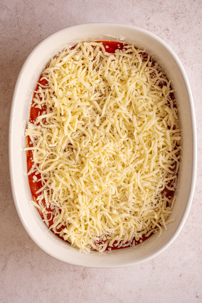 Mozzerella cheese overtop tomato sauce and cottage cheese to make pizza dip.