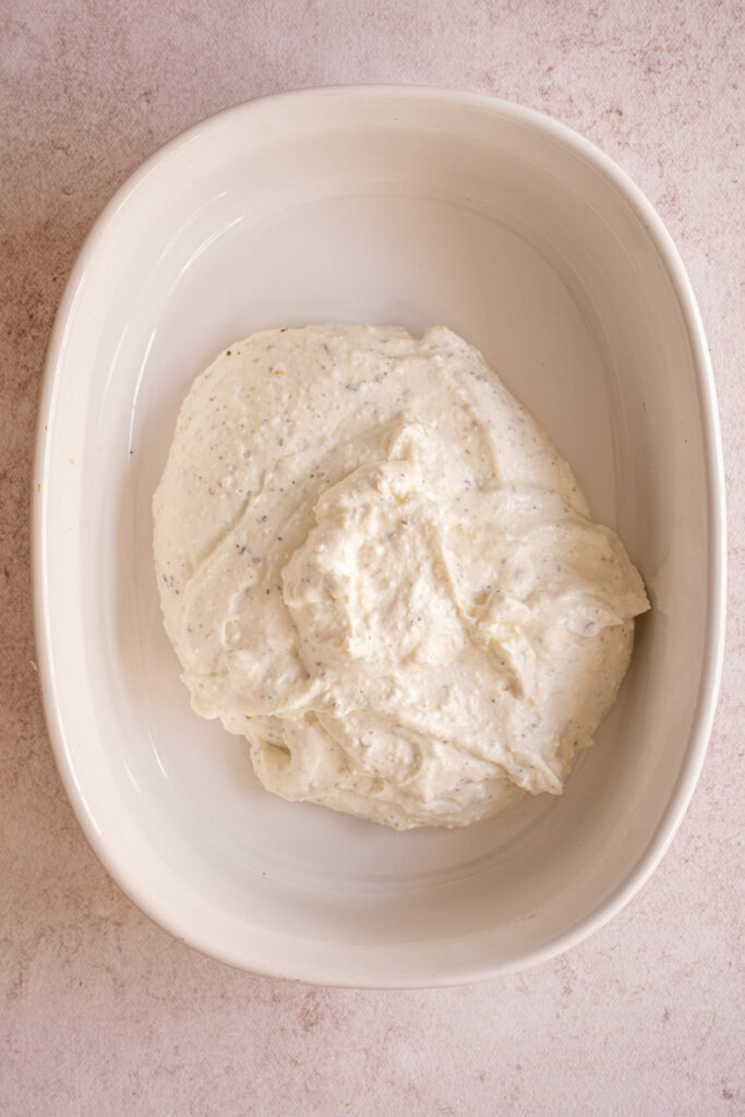 Blended cottage cheese scooped into a casserole dish.