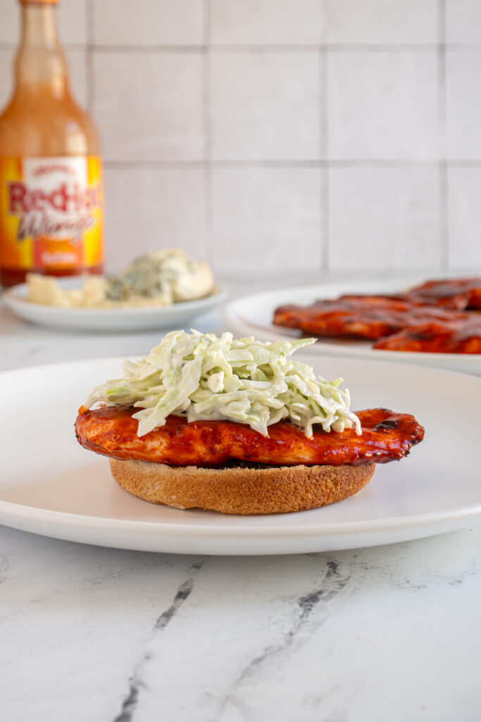 Blue cheese coleslaw added to the top of a buffalo chicken cutlet.
