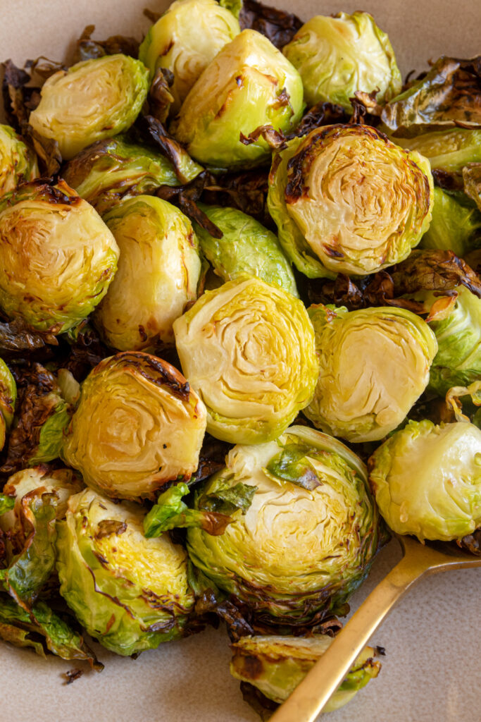 Tender yet crispy brussel sprouts in a brown bowl.