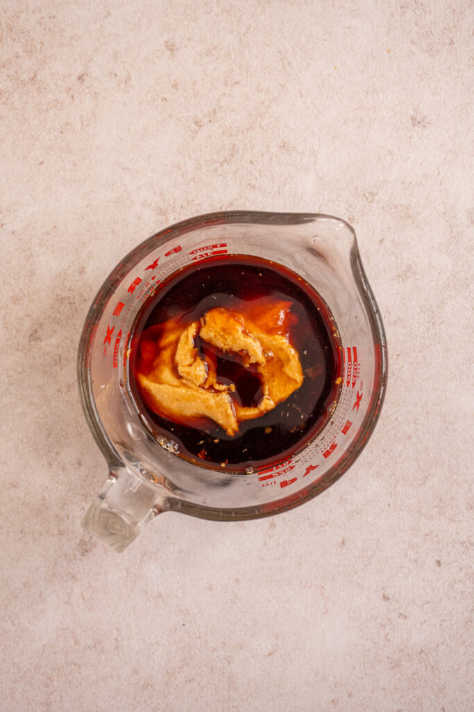The ingredients for the pad thai sauce in a measuring cup.