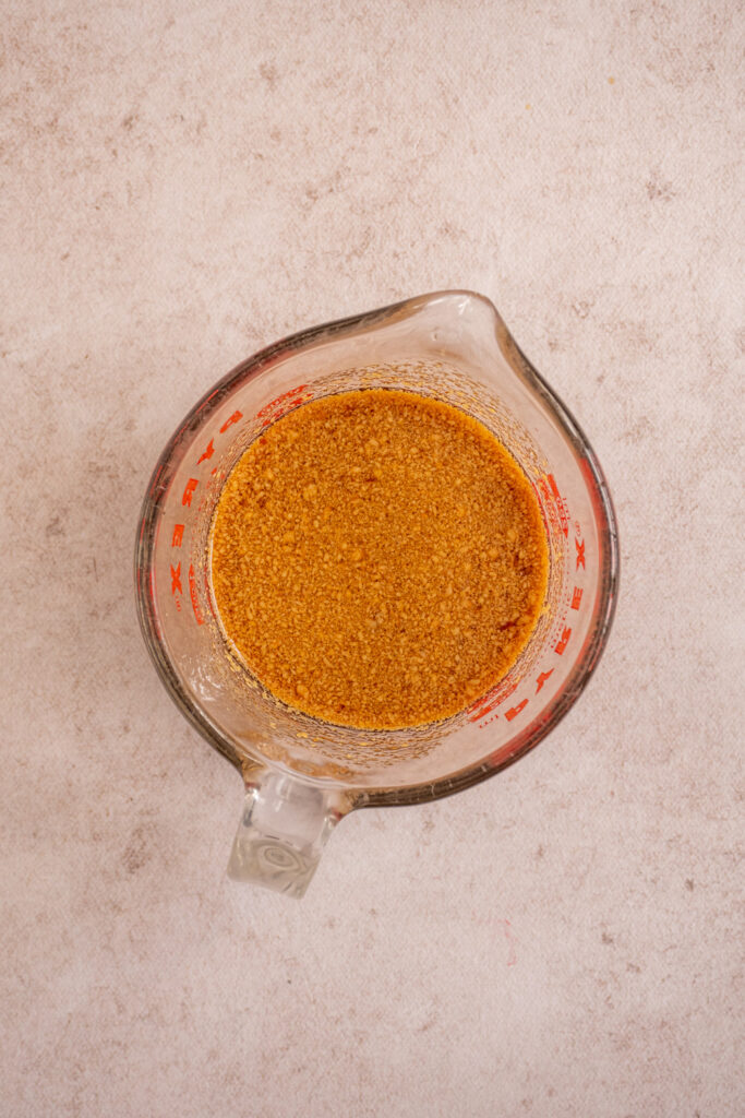 The sauce in a measuring cup mixed together for making pad thai.