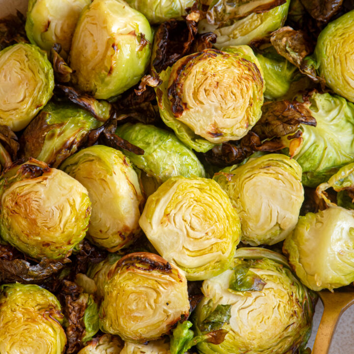 Crispy air fried brussel sprouts in a brown bowl.