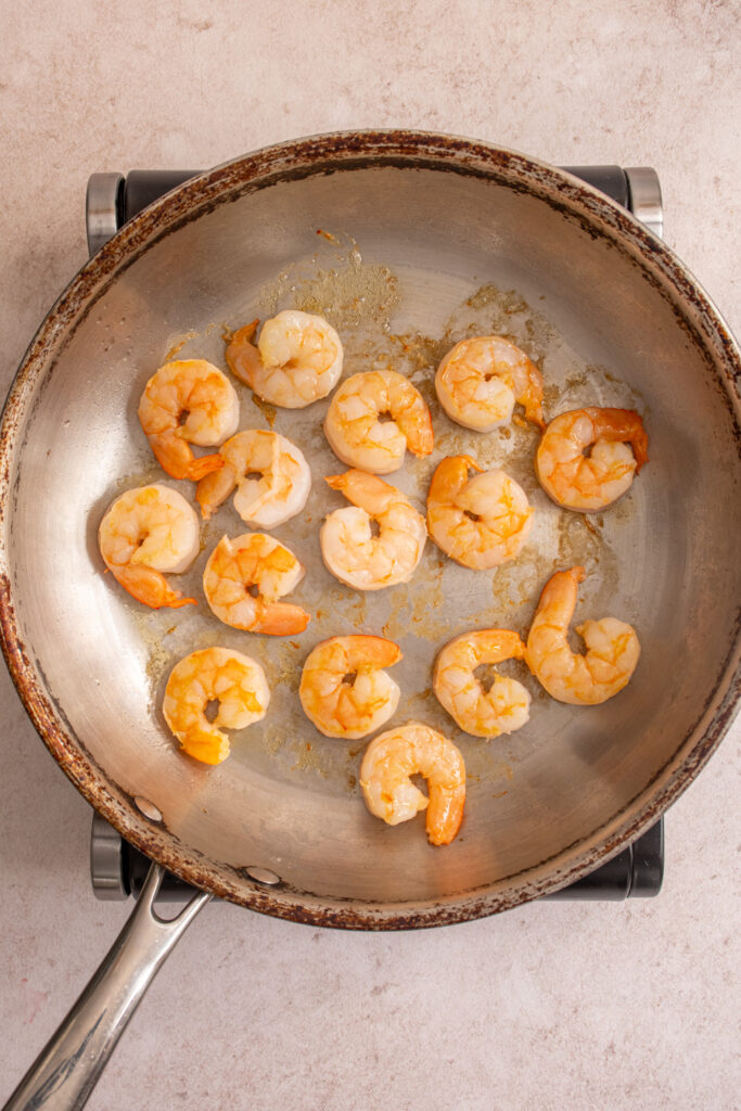 Cooked shrimp in a skillet.