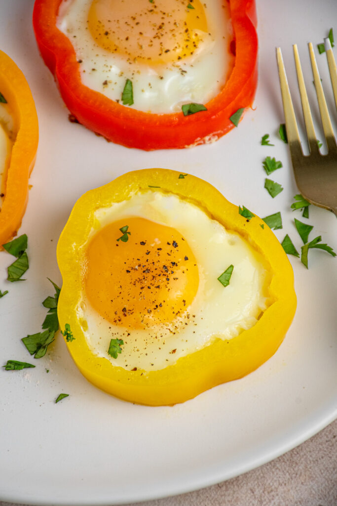 A bell pepper egg ring on a white plate.
