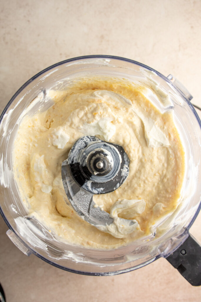Blended frozen peaches and greek yogurt in a food processor.