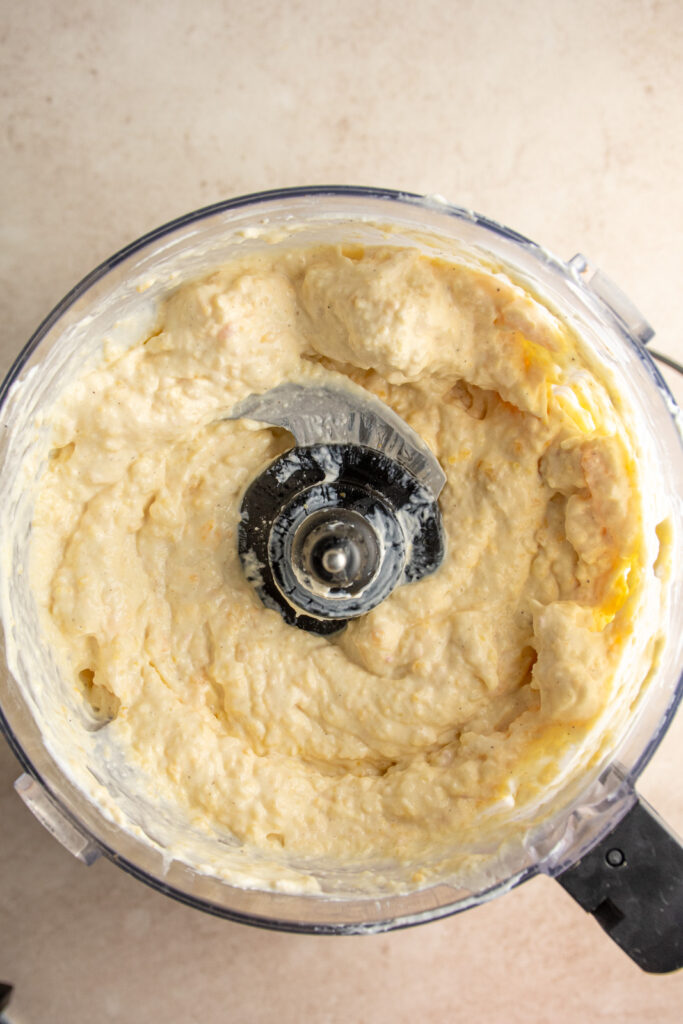A food processor filled with chunky peach yogurt.
