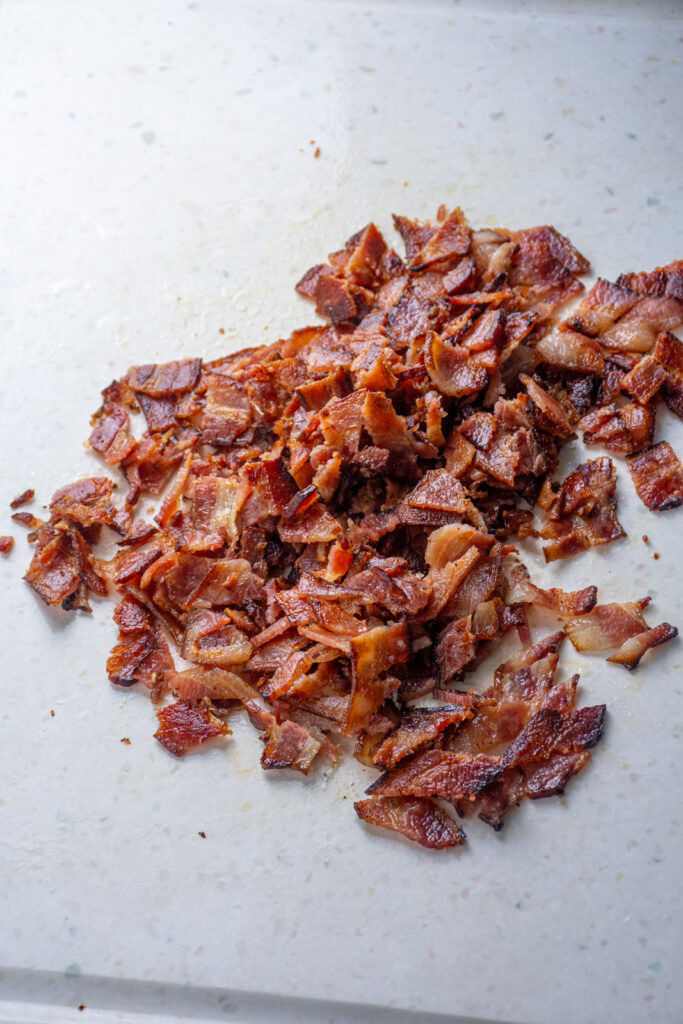 Chopped bacon on a cutting board.