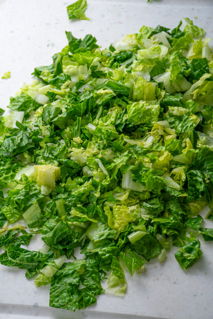 Chopped lettuce on a cutting board.