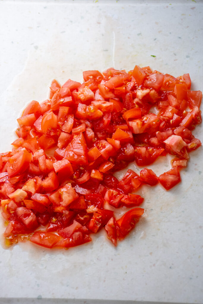 Chopped tomatoes on a cutting board.