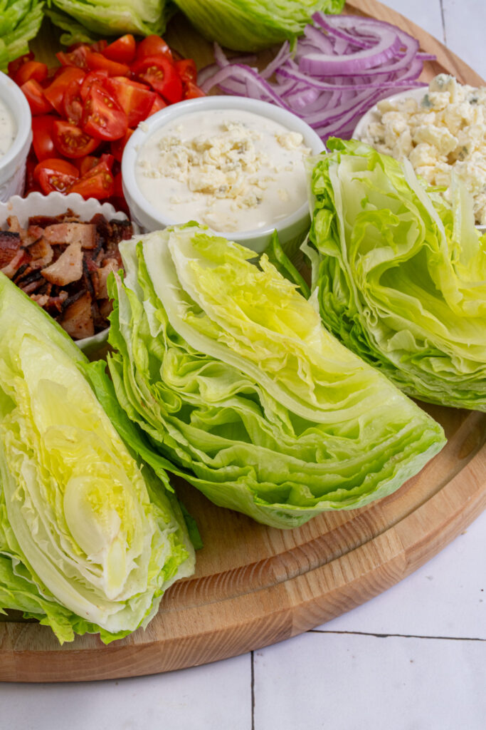 A close up of a wedge of iceberg lettuce on a wedge salad board.