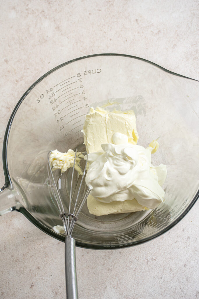 The start of making the topping with sour cream and softened cream cheese.