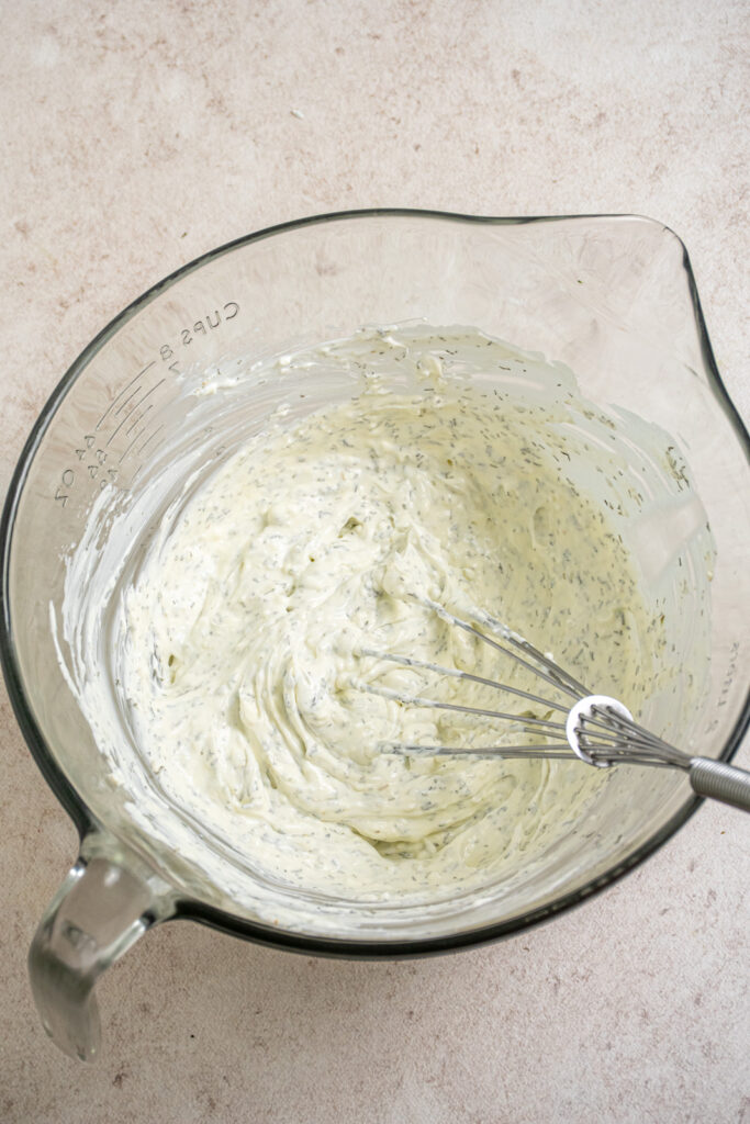 Smooth and creamy dill dip topping for the veggie pizza in a bowl.