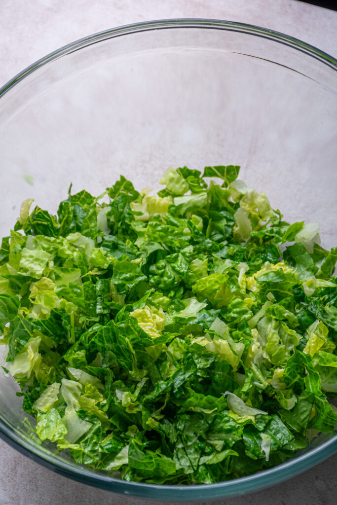 Chopped lettuce in a mixing bowl.