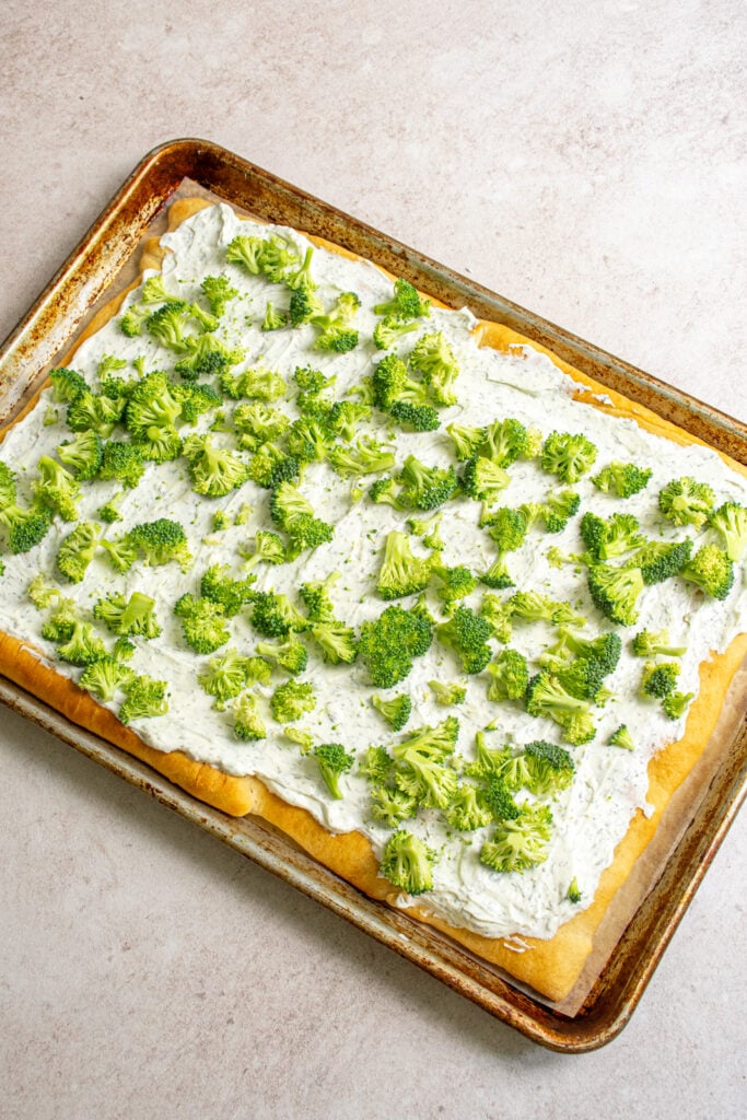 Broccoli added to the veggie pizza.