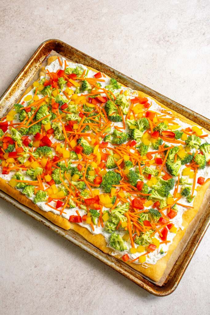 Red and yellow bell peppers added to the veggie pizza.