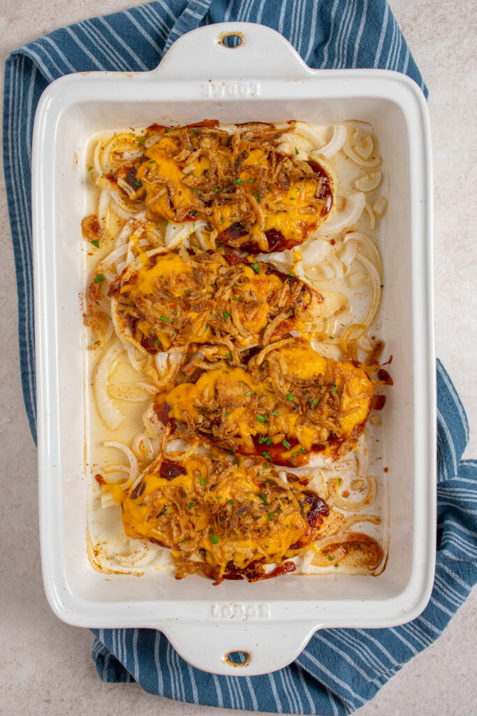 A casserole dish with cheesy bbq chicken baked in the oven.