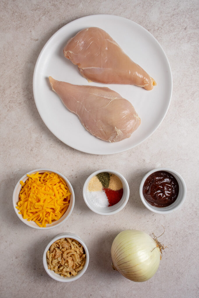 Ingredients for making cheesy bbq chicken bake on a table top.
