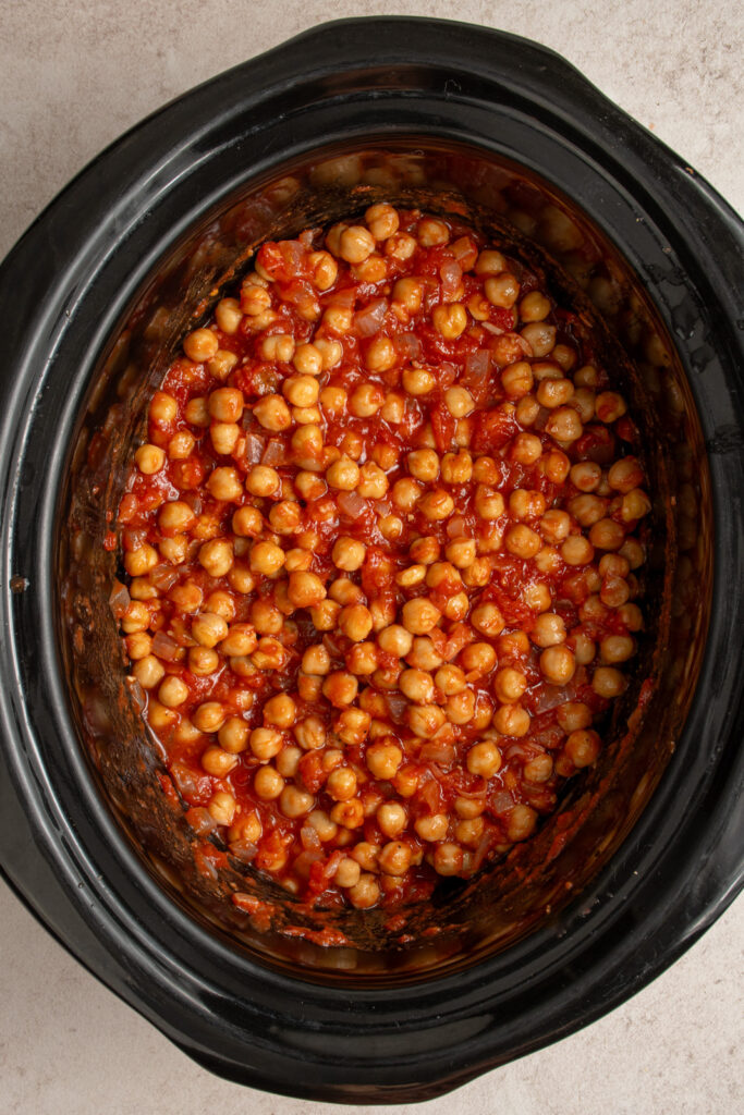 Crockpot filled with chickpea tikka masala before being cooked.