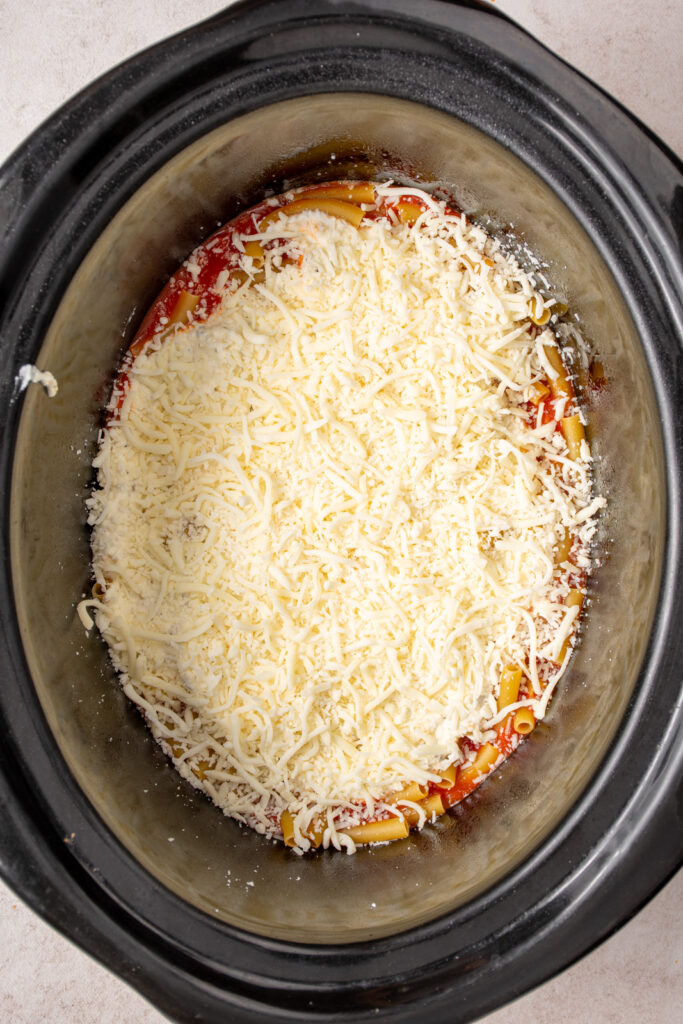 Added the shredded cheese blend to the crockpot overtop the ricotta cheese.