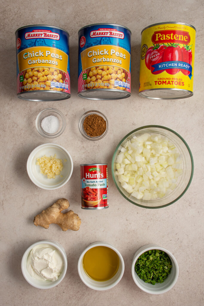 Ingredients needed to make chickpea tikka masala laid out on a tabletop.