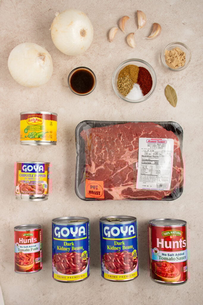 Ingredients needed to make chuck roast chili laid out on a table top.