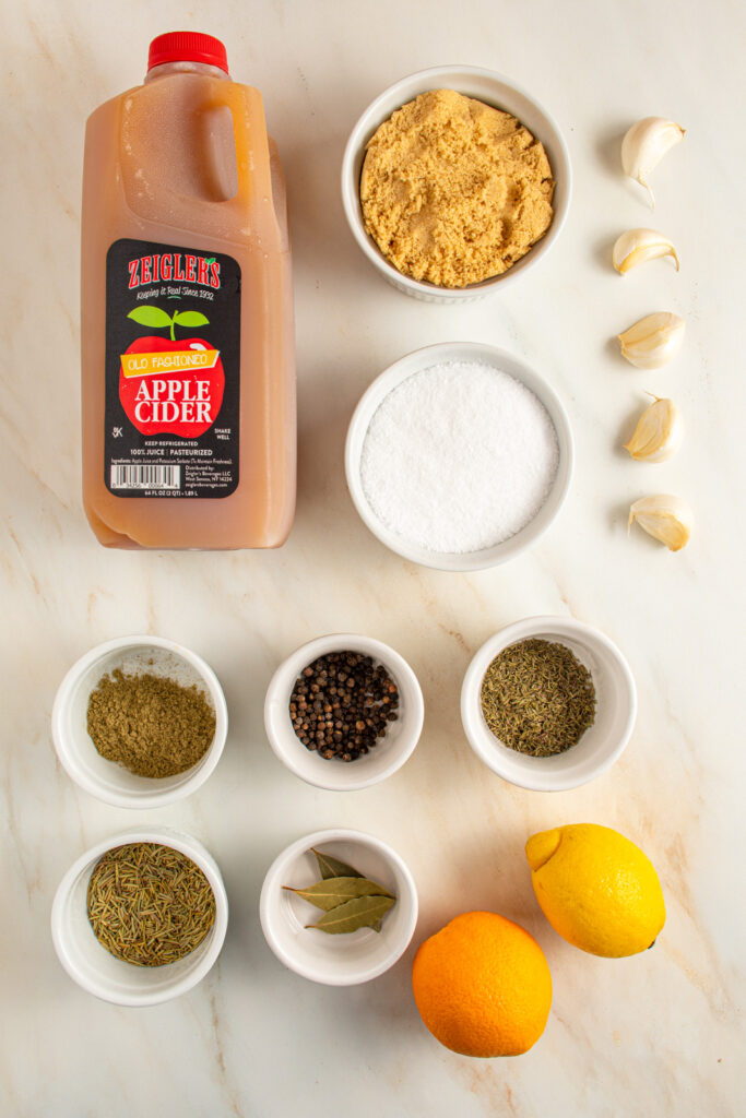 Ingredients to make apple cider turkey brine laid out on a tabletop.