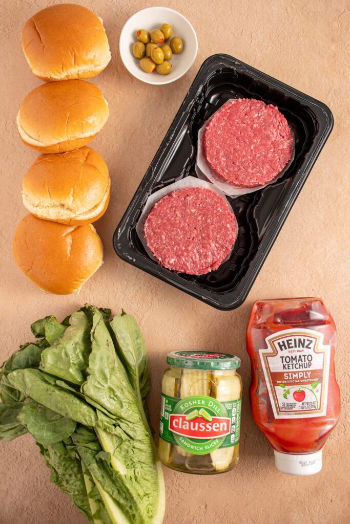 Ingredients needed to make halloween monster burgers on a tabletop.