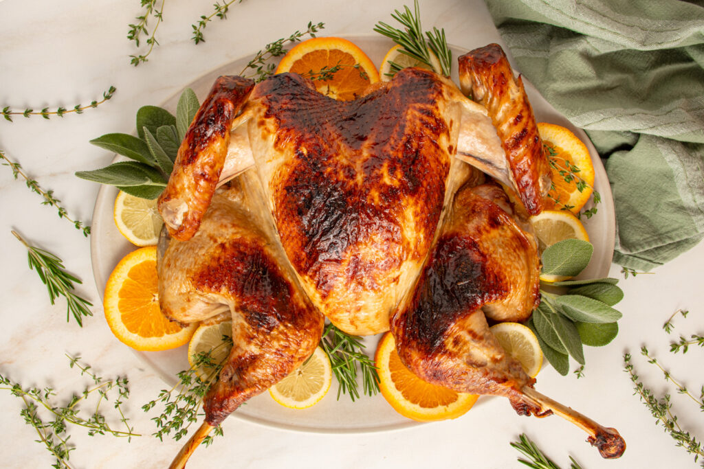 A roasted apple cider brine turkey on a serving platter.