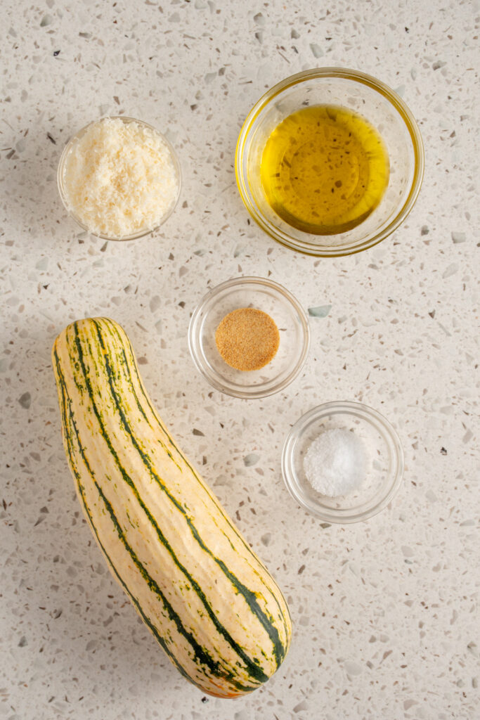 Ingredients to make air fryer delicata squash laid out on a table top.