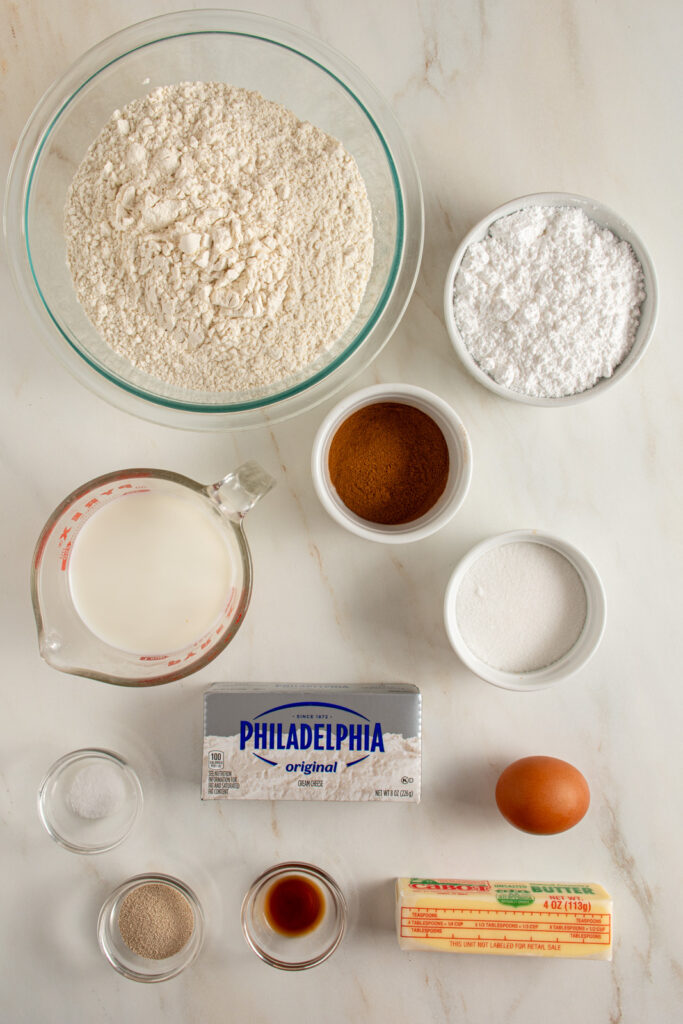 Ingredients needed to make small batch cinnamon rolls laid out on a tabletop.