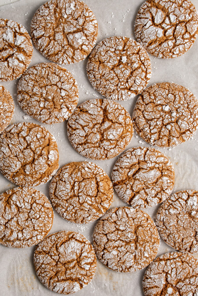 A baking sheet covered in gingerbread crinkle cookies.