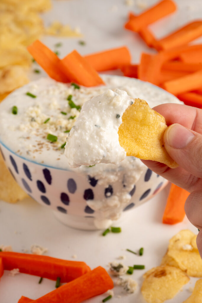 A chip with Blue Cheese Dip.