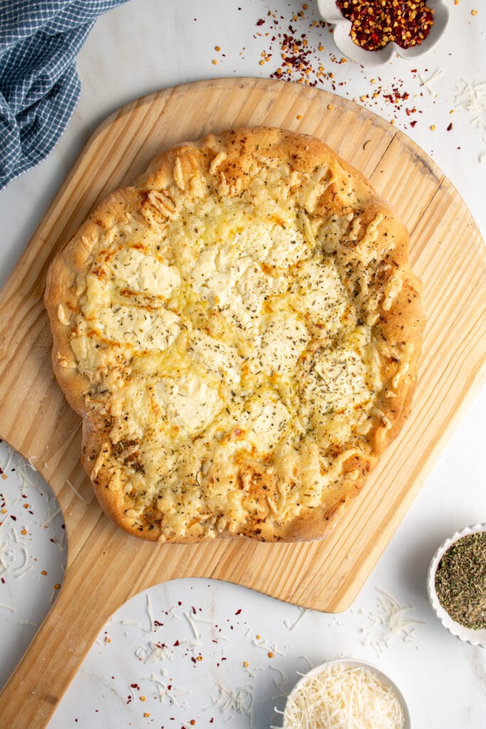 A white pizza on a pizza peel.