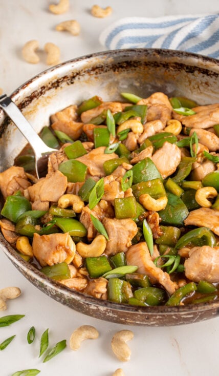 Skillet with chicken bell pepper stir fry.