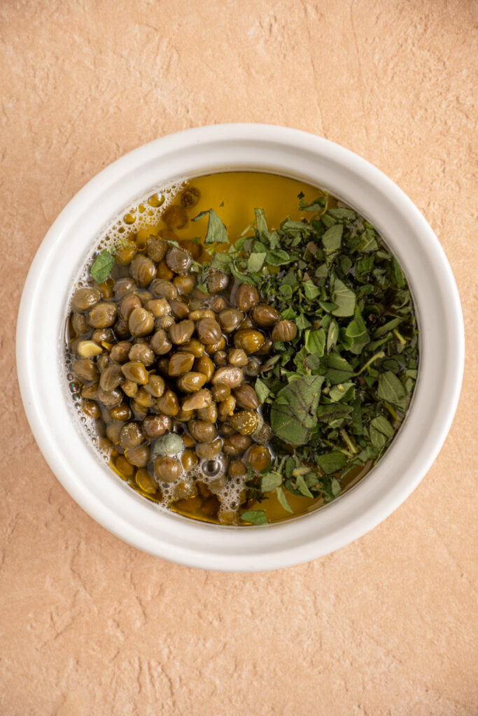 Ingredients in a bowl for making a caper lemon sauce.