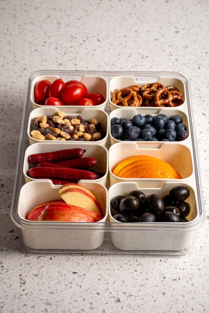 Snack box container filled with a bunch of different foods.