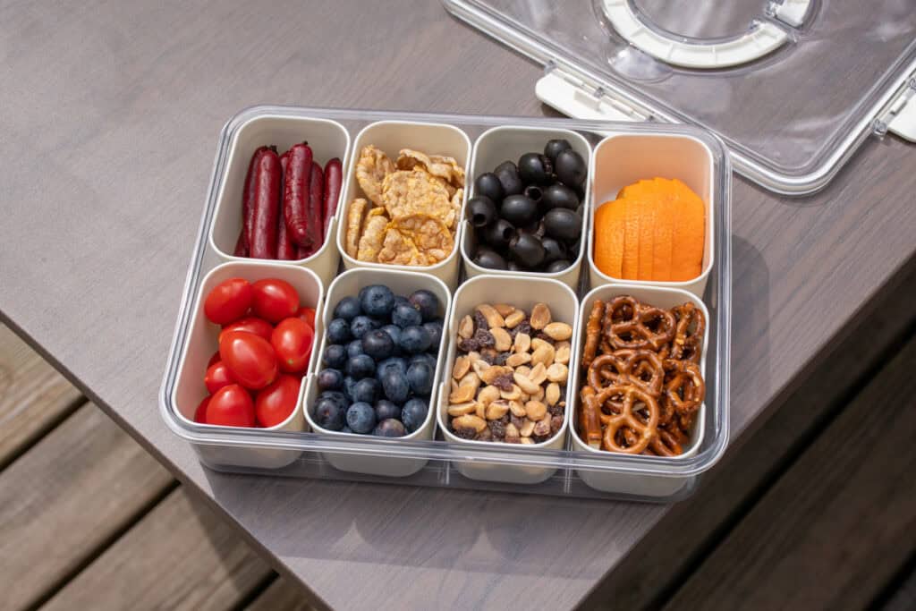 A snackle box filled with all different types of snacks.