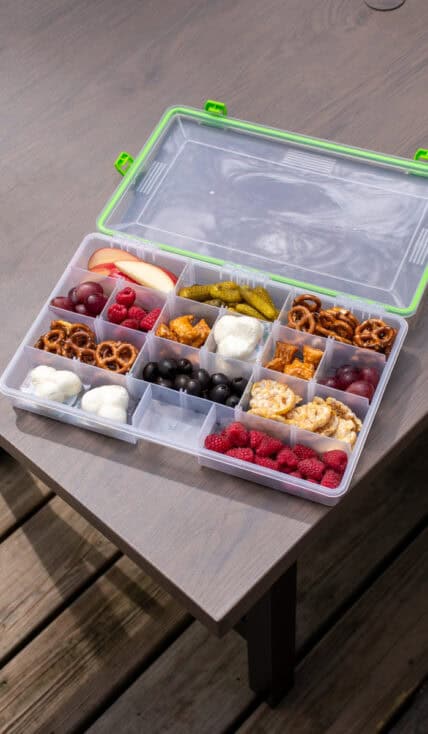 A snackle box filled with all different types of snacks.