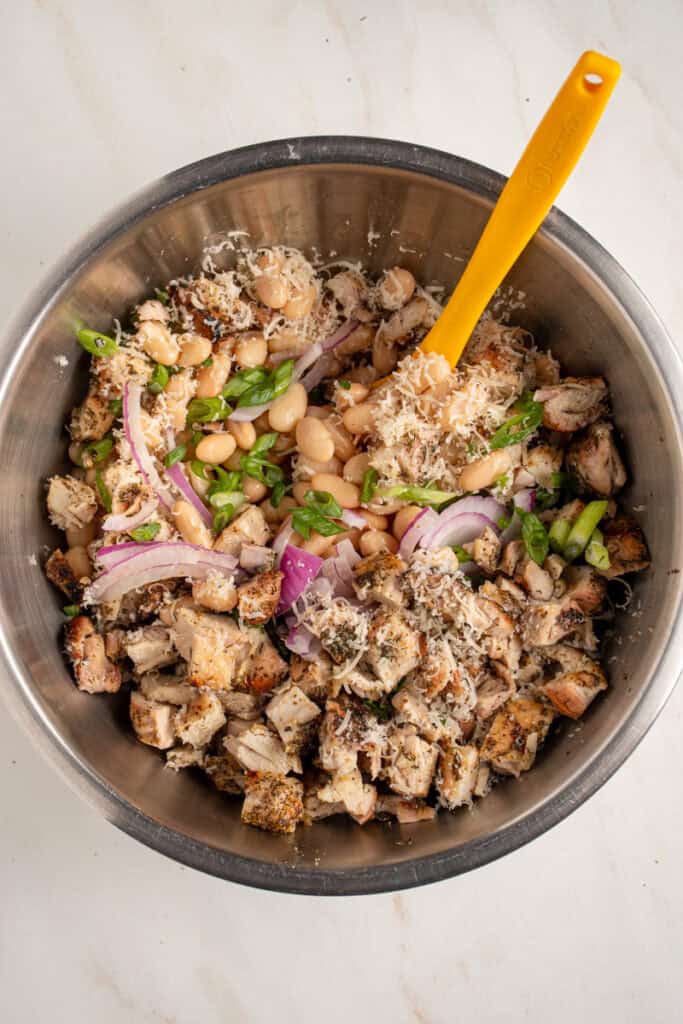 Mixing together the ingredients for dense white bean salad.