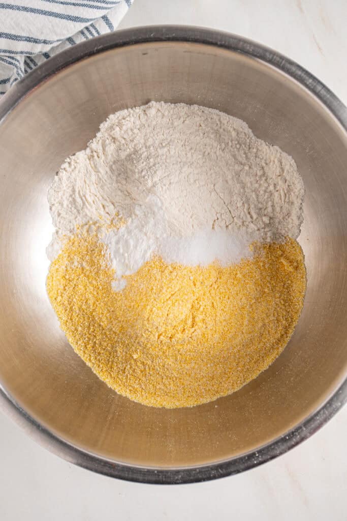 Dry ingredients to make fritters in a mixing bowl.
