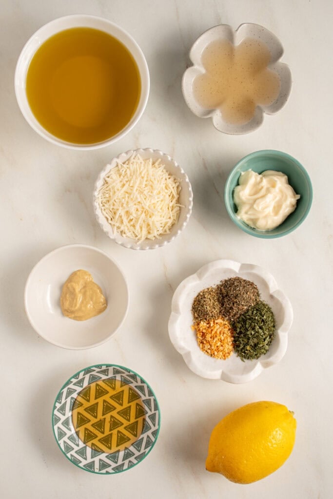 Ingredients laid out on a table top to make homemade Italian Dressing.