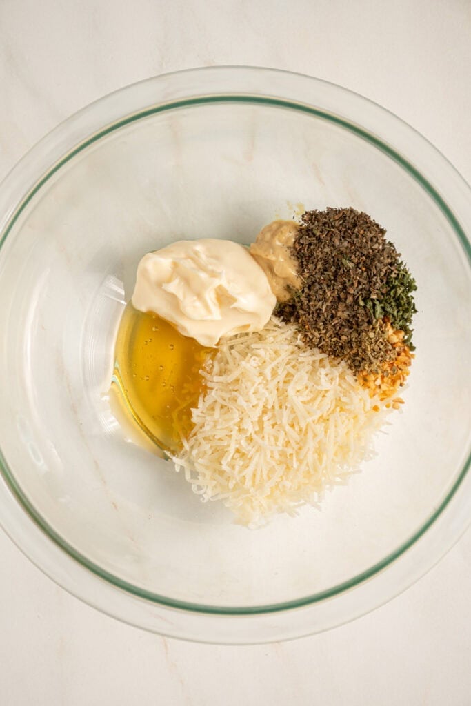 A bowl with the solid ingredients for making Italian Dressing.