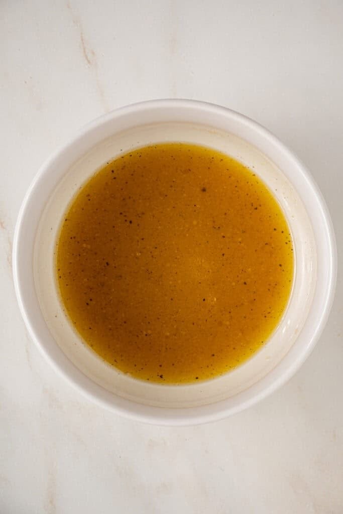 The dressing for the fall cobb salad in a bowl.