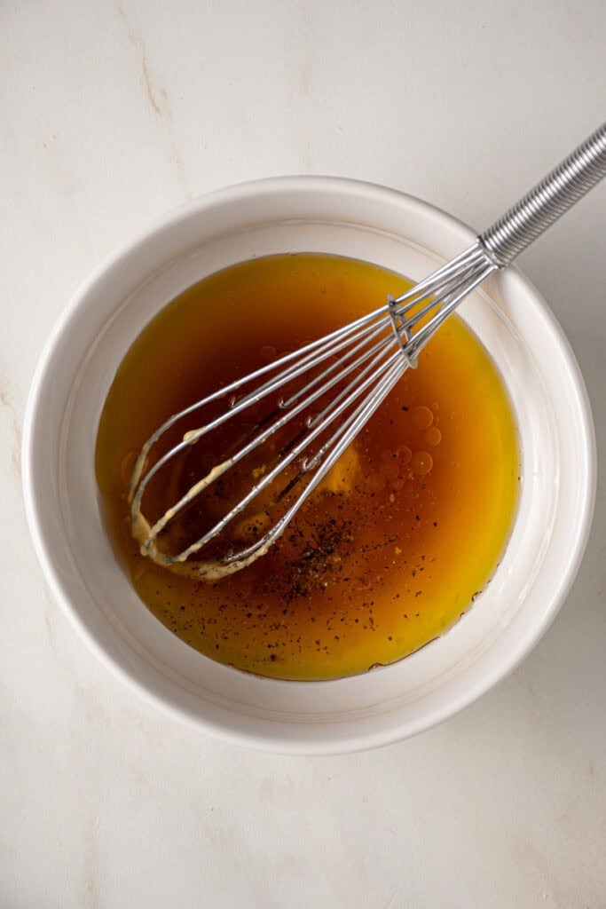A bowl with ingredients for making the dressing for the fall cobb salad.